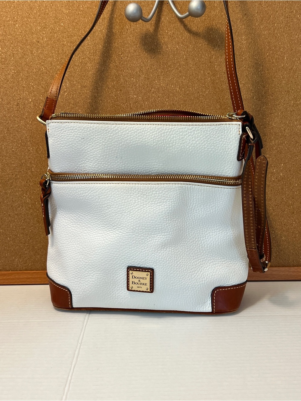 Dooney & Bourke White Leather Crossbody with Brown Trim and Gold Plaque